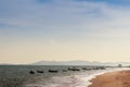 Beautiful sea, sand and fishing boats with mountain and blue sky Royalty Free Stock Photo