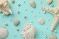 Beautiful sea shells, starfish, pearls and pebbles on light blue background, flat lay Royalty Free Stock Photo