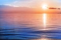 Beautiful sea sunset, morning ocean sunrise, tropical island beach, soft pink red orange sky clouds, yellow sun, blue water waves Royalty Free Stock Photo