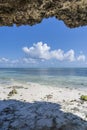 Beautiful sea view, blue sky and white clouds from the inside of the cliff on the island of Zanzibar, Tanzania, Africa. Travel and Royalty Free Stock Photo