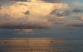 Beautiful sea view with the fishing boats and clouds formation in golden sunset hours, warm evening light, landscape Royalty Free Stock Photo