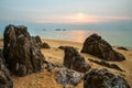 Beautiful sea view landscape with sunset light and big magmatic rock on the coastline