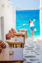 Beautiful sea view in outdoor cafe Mykonos on Cyclades islands. Young woman taking selfie with this amazing view Royalty Free Stock Photo