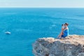 Beautiful sea view and woman sitting on mountain looking in binoculars. Travel time and new ground concept, copy space Royalty Free Stock Photo