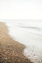 Beautiful sea waves foam closeup and sandy beach with seashells on tropical island. Waves in ocean bay or lagoon. Tranquil calm Royalty Free Stock Photo