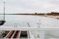 Beautiful seagulls sitting in port area. Seabird closeup, in a harbor. White Gulls standing on the white fence on Royalty Free Stock Photo