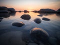 Beautiful seascape with big stones in the water at sunset. Made with Generative AI