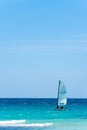 Beautiful seascape, a boat with a white sail on turquoise waves. Exotic Caribbean sea and clear blue sky. Yachting and Royalty Free Stock Photo