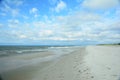 Beautiful seascape with a dark blue sea, long coast line, sandy beach and blue sky on a sunny day