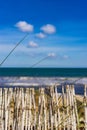 Maritime beach background with dunes sand fence and sea water waves Royalty Free Stock Photo