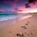 Beautiful seascape with footprints in the sand at sunset time