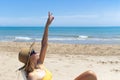 Beautiful seascape with a girl, a slender girl in a hat and swimsuit relaxes and lies on a sun lounger on the beach Royalty Free Stock Photo