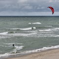 Beautiful seascape with kitesurfer, riding waves.