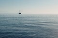 Beautiful seascape. Minimalistic view of the sea and sailing ship in the early morning. Sailing in the sea in the morning sunlight Royalty Free Stock Photo