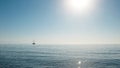 Beautiful seascape. Minimalistic view of the sea and sailing ship in the early morning. Sailing in the sea in the morning sunlight Royalty Free Stock Photo