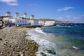 Beautiful seascape of Mykonos with the beach and windmills on hill, Greece