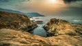 Beautiful seascape, ocean views, rocky coast, sunlight on the horizon. Composition of nature. Sunset scenery background. Cloudy Royalty Free Stock Photo