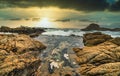 Beautiful seascape, ocean views, rocky coast, sunlight on the horizon. Composition of nature. Sunset scenery background. Cloudy Royalty Free Stock Photo