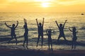 Beautiful seascape paradise view with blurry people silhouette jumping on the beach in twilight time. Royalty Free Stock Photo