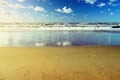 Beautiful seascape with sea waves, blue sky, white cumulus clouds and sand beach. Summer vacation tropical landscape. Royalty Free Stock Photo