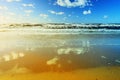 Beautiful seascape with sea waves, blue sky, white cumulus clouds and sand beach. Summer vacation tropical landscape. Royalty Free Stock Photo