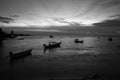 Seascape with boats and fishermen after sunset. black and white photo