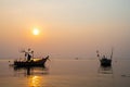 Beautiful seascape sunset with silhouette fishing wood boat floating down or park on sea in asia thailand Royalty Free Stock Photo