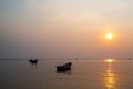 Beautiful seascape sunset with silhouette fishing wood boat floating down or park on sea in asia thailand Royalty Free Stock Photo
