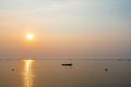 Beautiful seascape sunset with silhouette fishing wood boat floating down on sea in asia Royalty Free Stock Photo