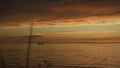 Beautiful seascape with sunset sky and ship on horizon. Clip. Magnificent view of sea sunset with red clouds and ship on Royalty Free Stock Photo