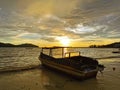 Beautiful seascape view with a boat during sunset at Kota Belud beach,Sabah.
