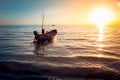 Beautiful seascape view the fishing boat floating on the sea with sunset light in the background. Royalty Free Stock Photo