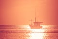 Beautiful seascape view of fishing boat floating on the sea with sunset light in the background. Royalty Free Stock Photo