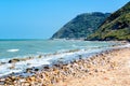 Beautiful seascape with view on sea and mountains on summer day, sea shore with pebble stones and cutwater. Adriatic Royalty Free Stock Photo