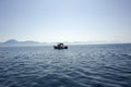 Beautiful seascape with a yacht anchored offshore in a cobalt blue sea. Fishing. Royalty Free Stock Photo