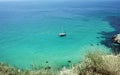 Beautiful seascape with a yacht, blue transparent water and white sand