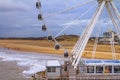 Beautiful seaside landscape - view of the beach through a ferris wheel near the embankment of The Hague Royalty Free Stock Photo