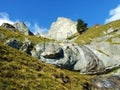 Beautiful seasonal waterfalls under alpine rocks FalknistÃÂ¼rm in the Ratikon border mountain massif or Raetikon Grenzmassiv