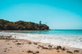 Beautiful secluded beach on an isolated island. Blue water and white waves spume on a sandy beach with stones in Sri Lanka. Escape