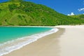 Beautiful secluded empty tropical lonely lagoon, white sand beach, turquoise water, lush green hill, blue summer sky - Kuta ,