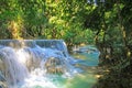 Beautiful secluded lonely tropical waterfall landscape, green jungle forest, rock cascade, blue turquoise river - Kuang Si, Luang