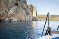 People taking delight in kayaking and boating alongshore. Coastline.