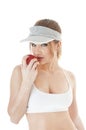 Beautiful seductive female tennis player with red apple.