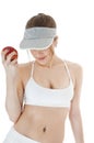 Beautiful seductive female tennis player with red apple.