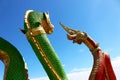 Beautiful Green and Red colors of Praya Nark or Naga in Thai temple with colorful sky and sun flare effect on sunrise time Royalty Free Stock Photo