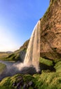 Beautiful Seljalandsfoss Waterfall during golden hour - portrait format, Sudurland, Iceland