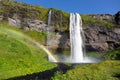 Beautiful Seljalandsfoss waterfall and rainbow in Iceland, icelandic summer nature and river landscape