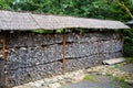 Beautiful semi-antique straw firewood shed. Wood wall