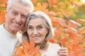 Beautiful senior couple in autumn park with leaves Royalty Free Stock Photo