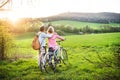 Beautiful senior couple with bicycles outside in spring nature. Royalty Free Stock Photo